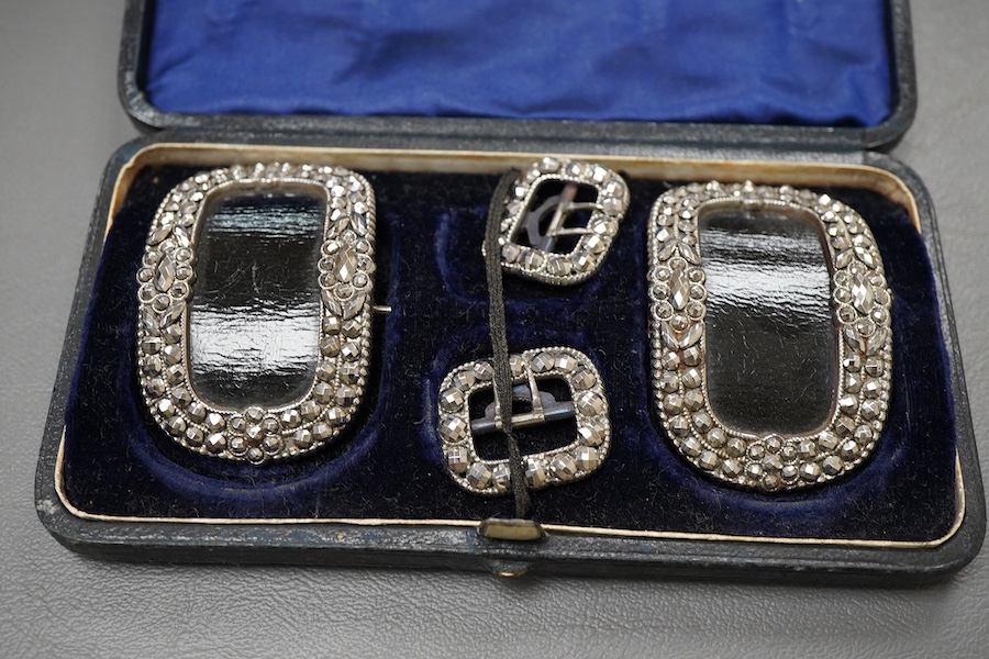 A collection of cased buckles, 19th century, two sets in cut steel, one set in gilt metal, each in a fitted case